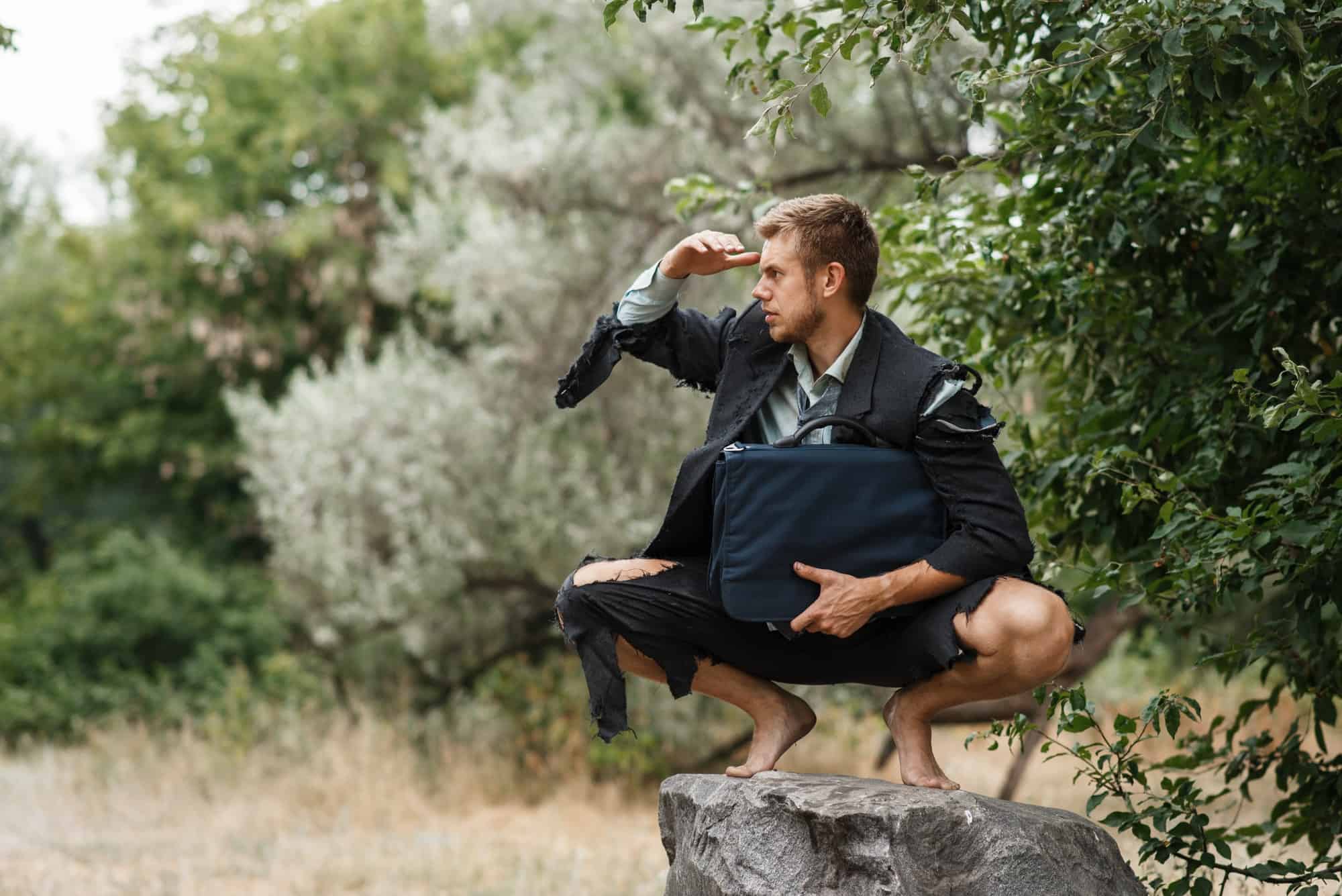 Businessman sitting on the stone, lost island